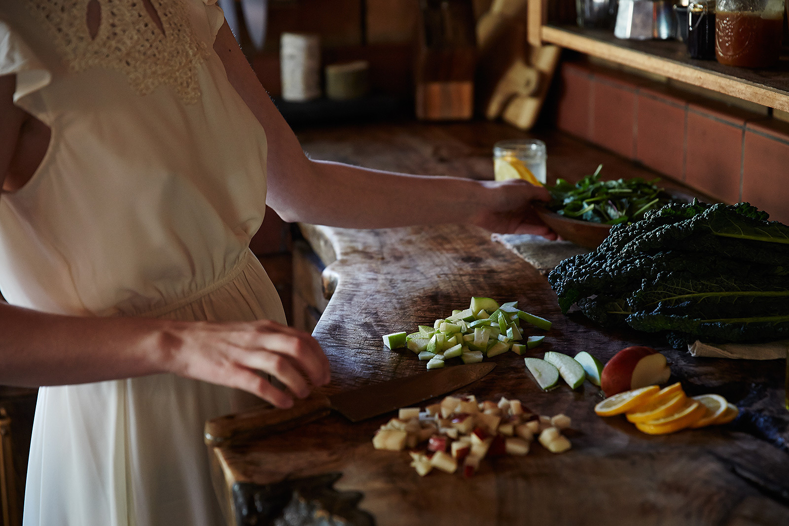 Woman cooking in rustic kitchen  | Trinette+Chris Photographers