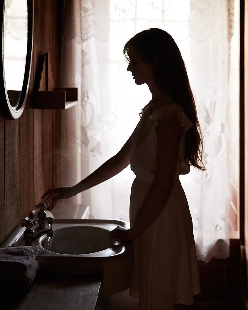Woman in cabin bathroom, CA  | Trinette+Chris Photographers