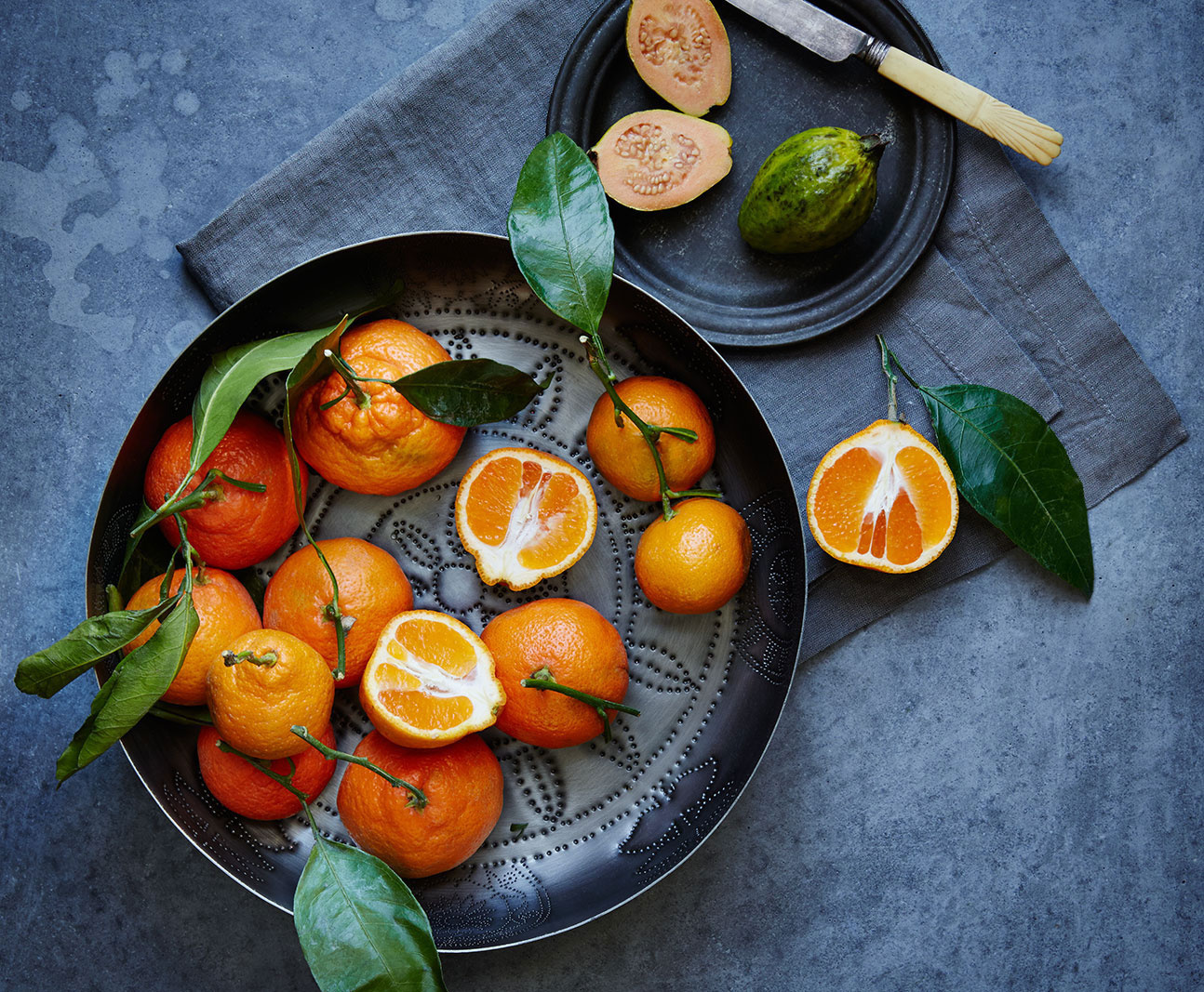 Oranges on grey concrete surface | Trinette+Chris Photographers